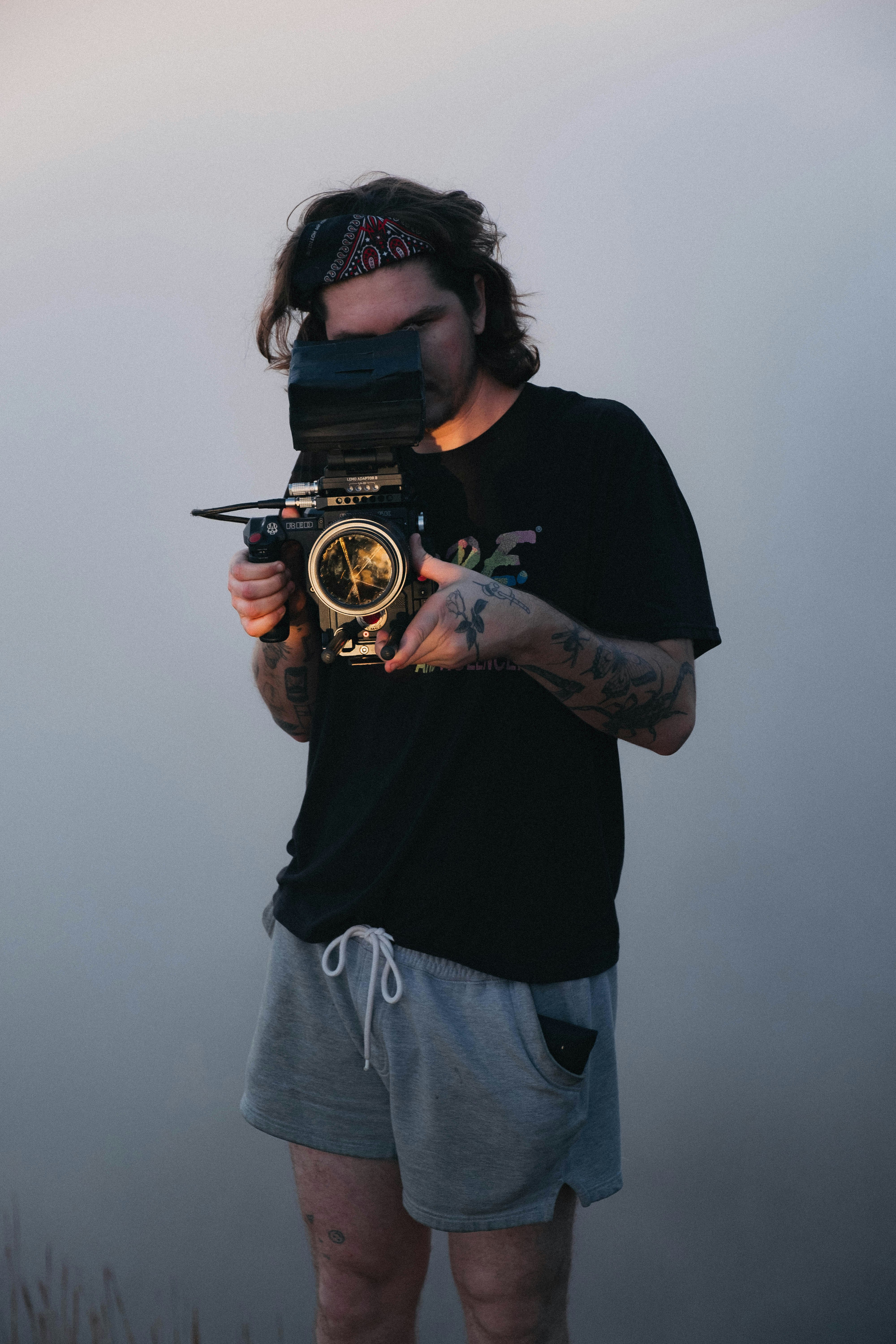man in black tee shirt using camera